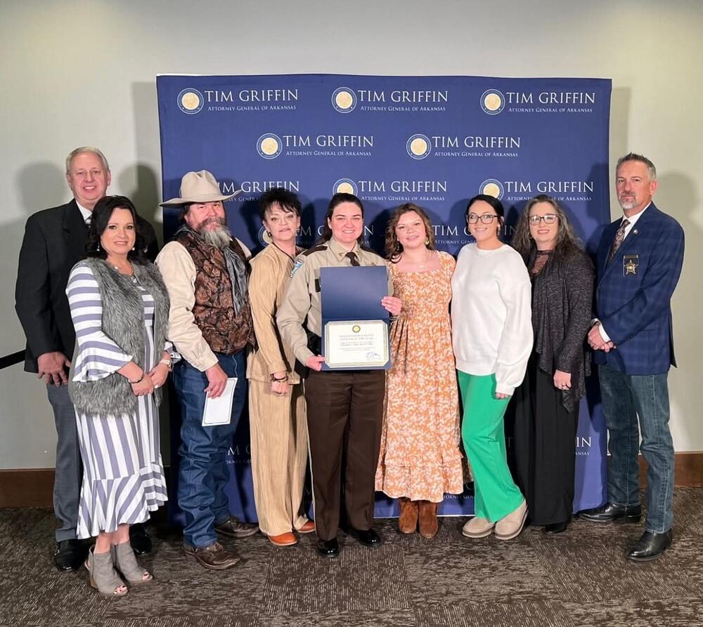 Award Photo with Sheriff Thomas Sergeant McCaghren and her family
